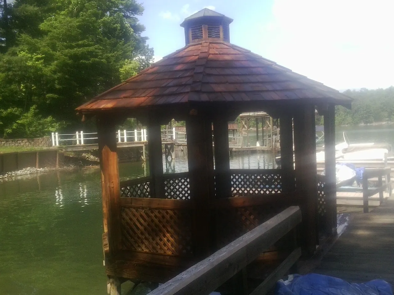 Cedar shake gazebo roof rebuilt on a lake dock in Joice